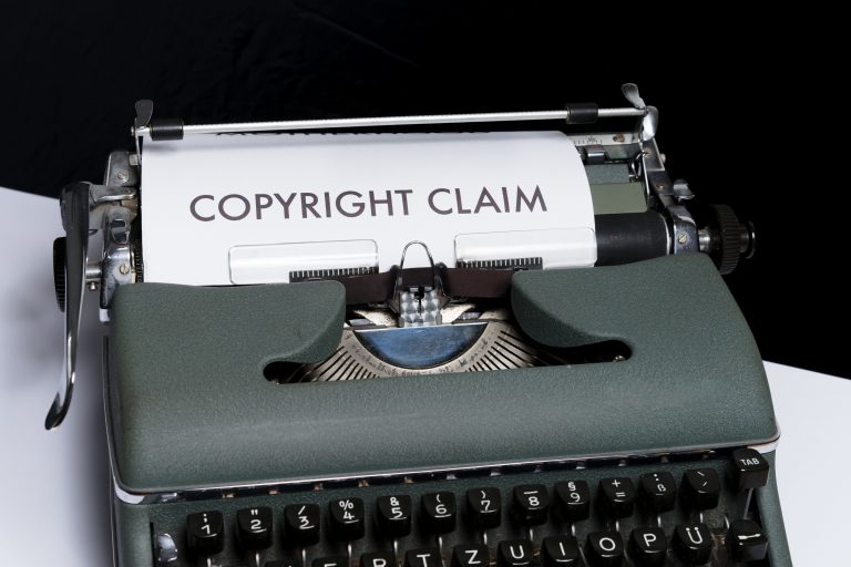 a typewriters with a paper with "copyright claim" typed on it