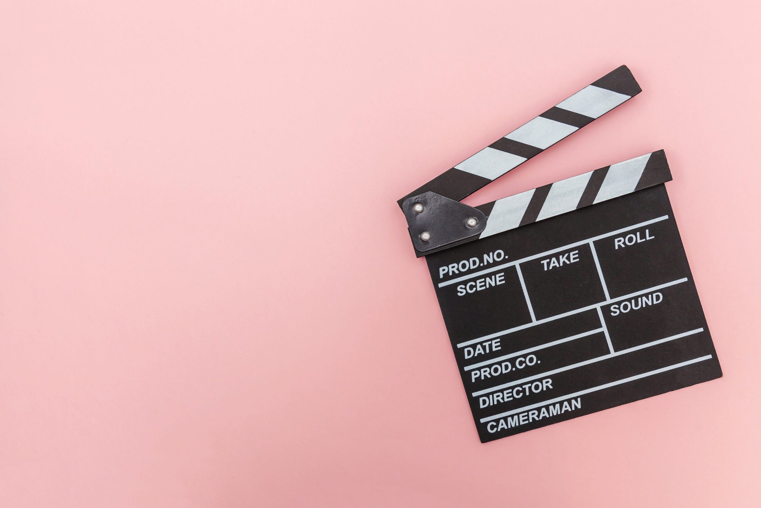 clapper board with a pink background