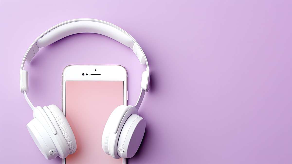 a pair of headphones and a phone on a purple background