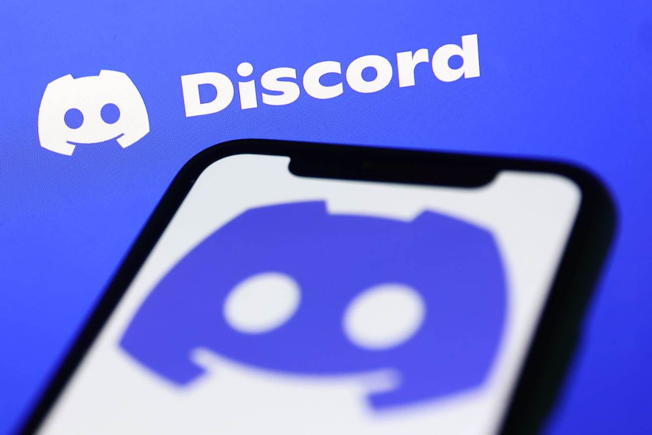 Discord logo on a phone with a Discord logo in the background