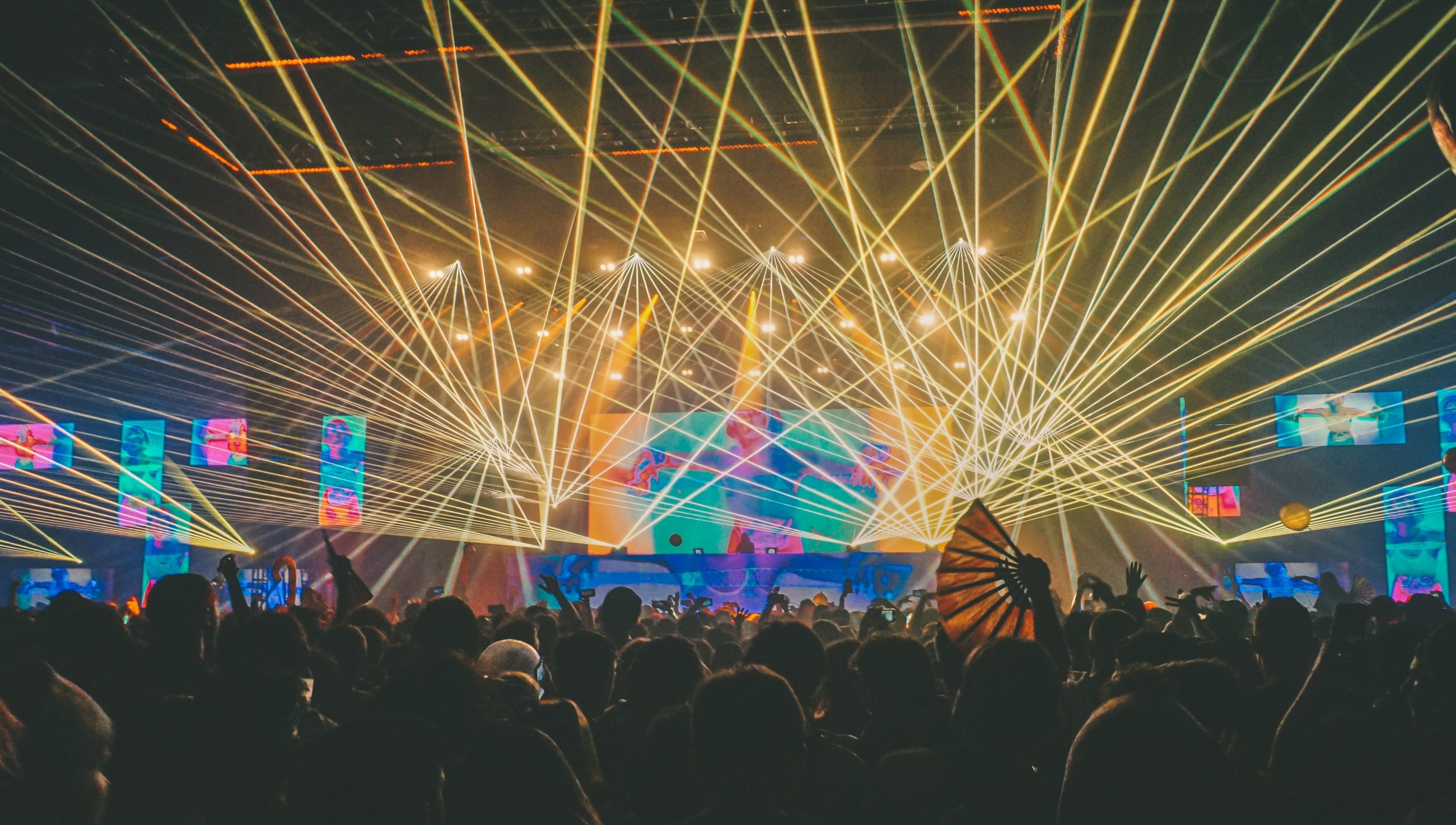 people gathering near the stage at a music festival