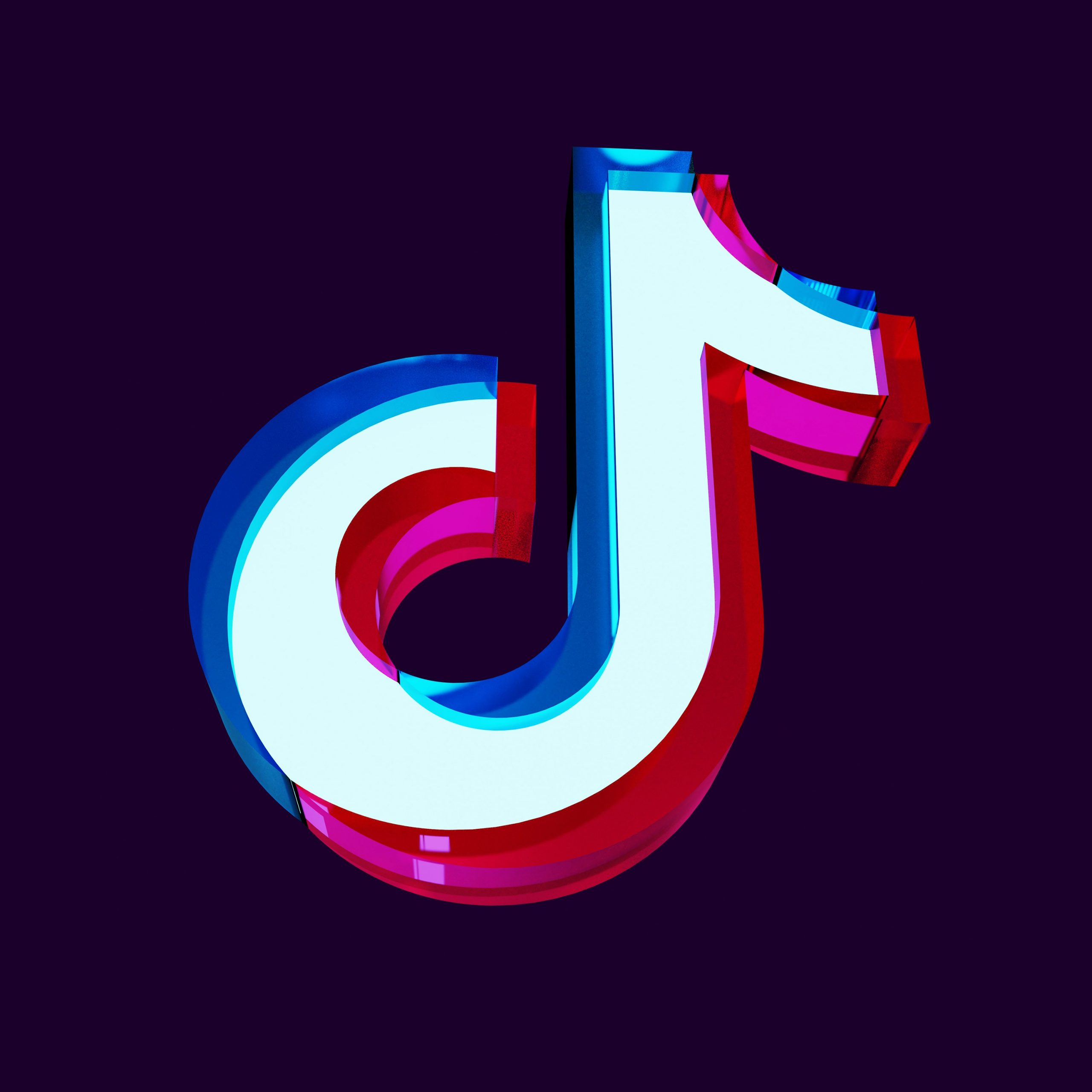 The TikTok logo in red, white and blue on a black background