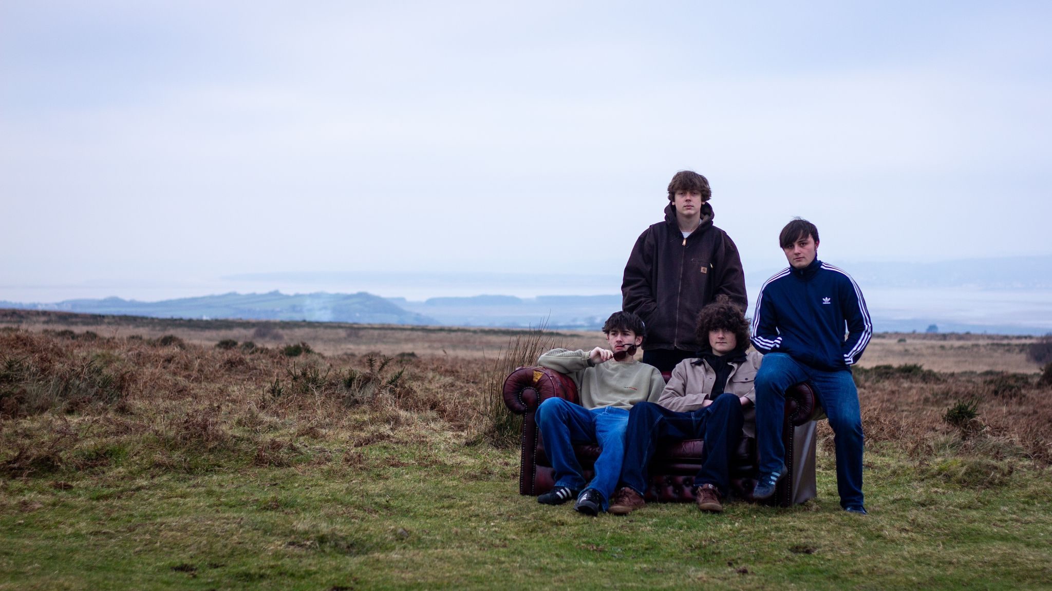 Four members of the band Subterrania with the backdrop of the wilderness